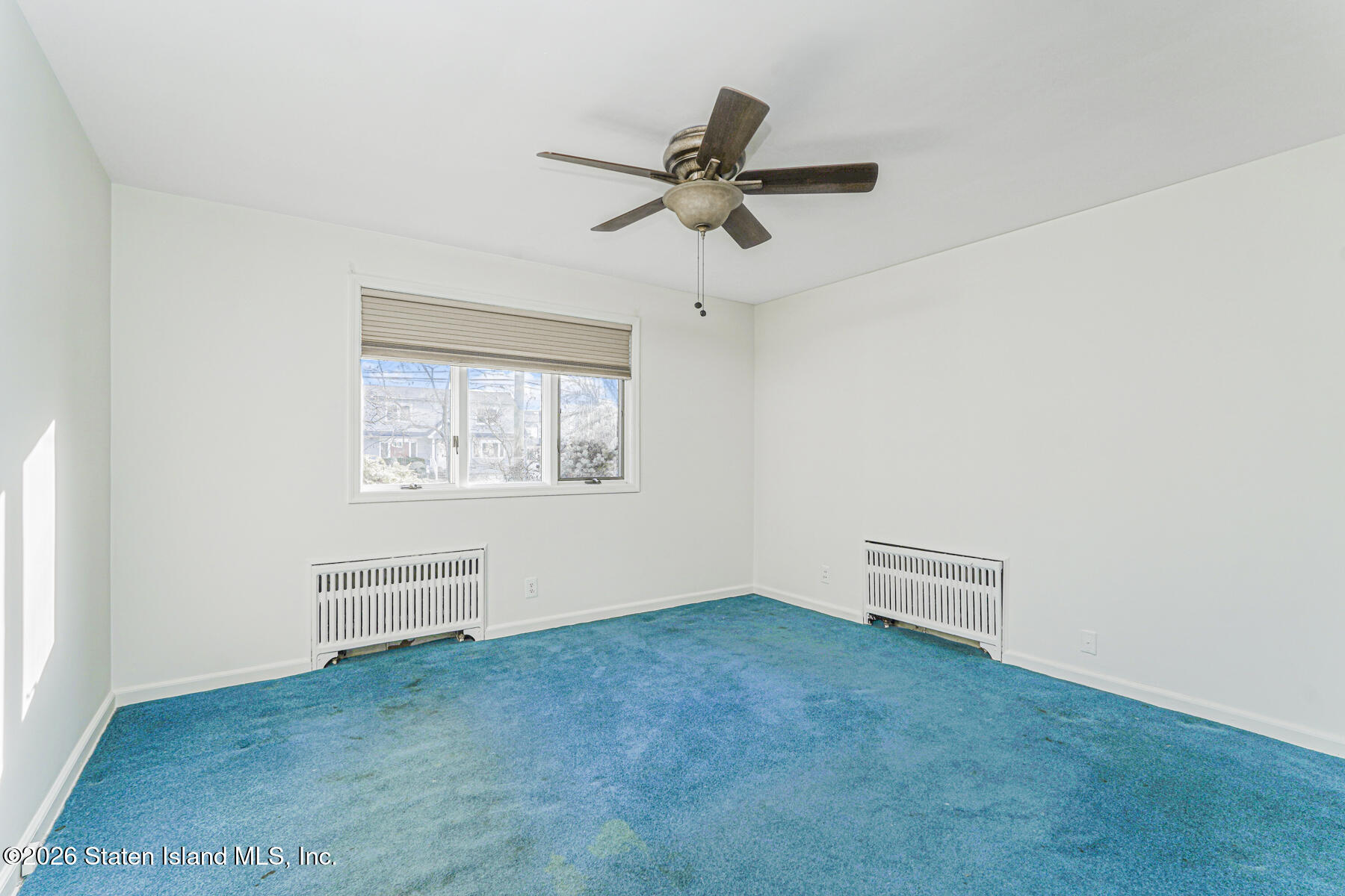 35 Rice Avenue Staten Island, NY 10301 - Photo 16 of 33 an empty room with windows and fan