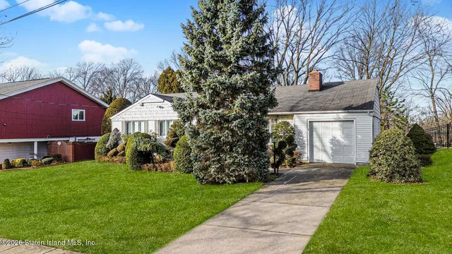 a front view of a house with a garden
