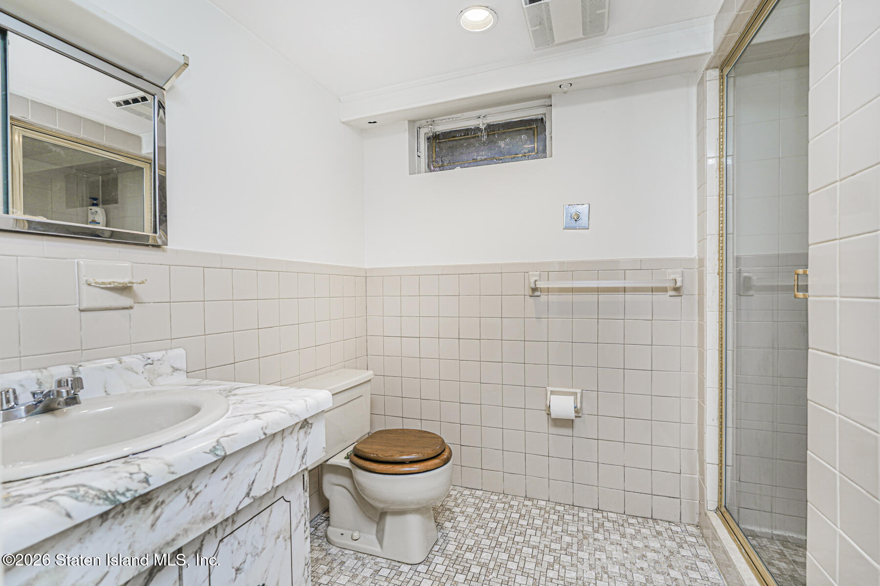 35 Rice Avenue Staten Island, NY 10301 - Photo 23 of 33 a bathroom with a granite countertop toilet sink and mirror