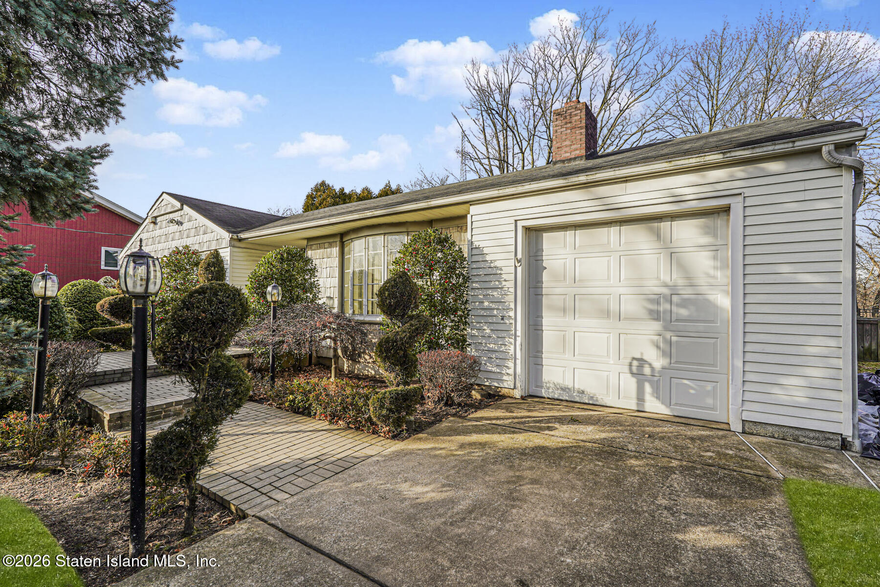 35 Rice Avenue Staten Island, NY 10301 - Photo 3 of 33 a view of a house with a large window and potted plants