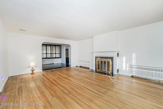 a bedroom with a bed and a view of kitchen