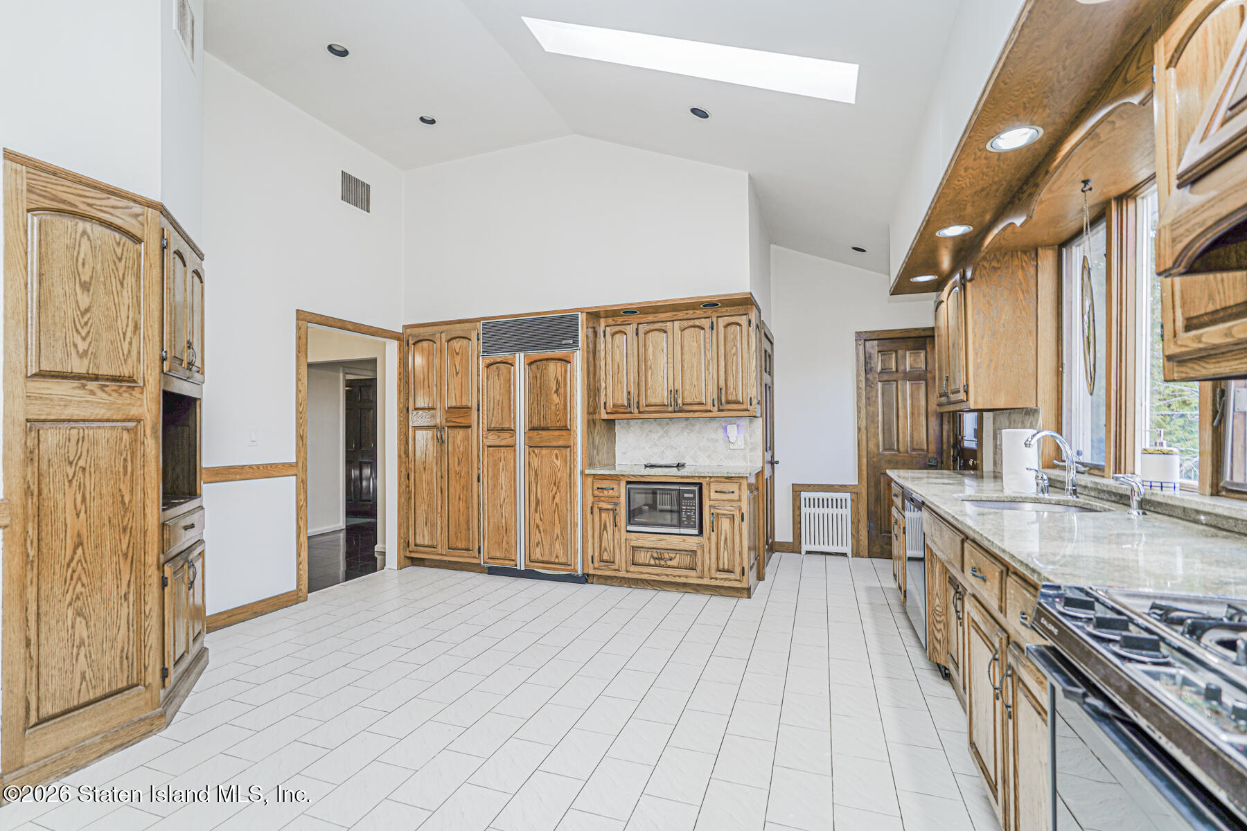 35 Rice Avenue Staten Island, NY 10301 - Photo 8 of 33 a kitchen with stainless steel appliances granite countertop a refrigerator a stove and a sink with cabinets