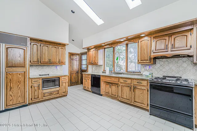 a kitchen with stainless steel appliances granite countertop a stove and a sink