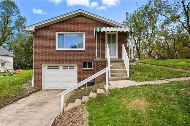 a view of house with backyard