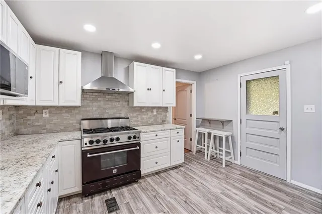 a kitchen with granite countertop a stove and a sink