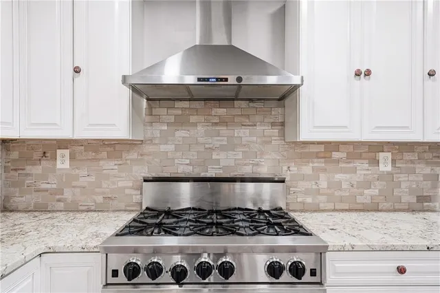 a stove top oven sitting inside of a kitchen