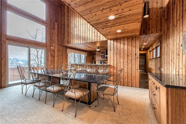 a view of a porch with furniture and floor to ceiling window