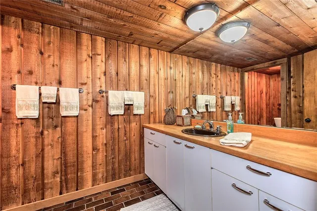 a kitchen with a large window and cabinets