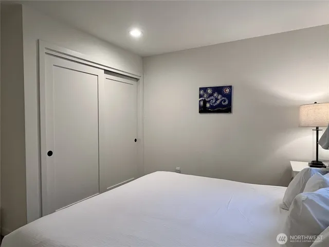 a bedroom with a bed and a lamp