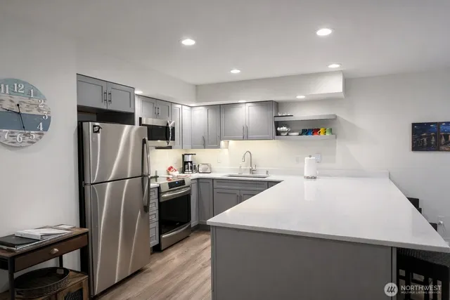 a kitchen with refrigerator a stove and a refrigerator