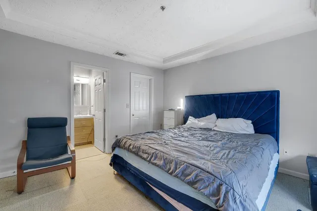 a bedroom with a bed and a chair