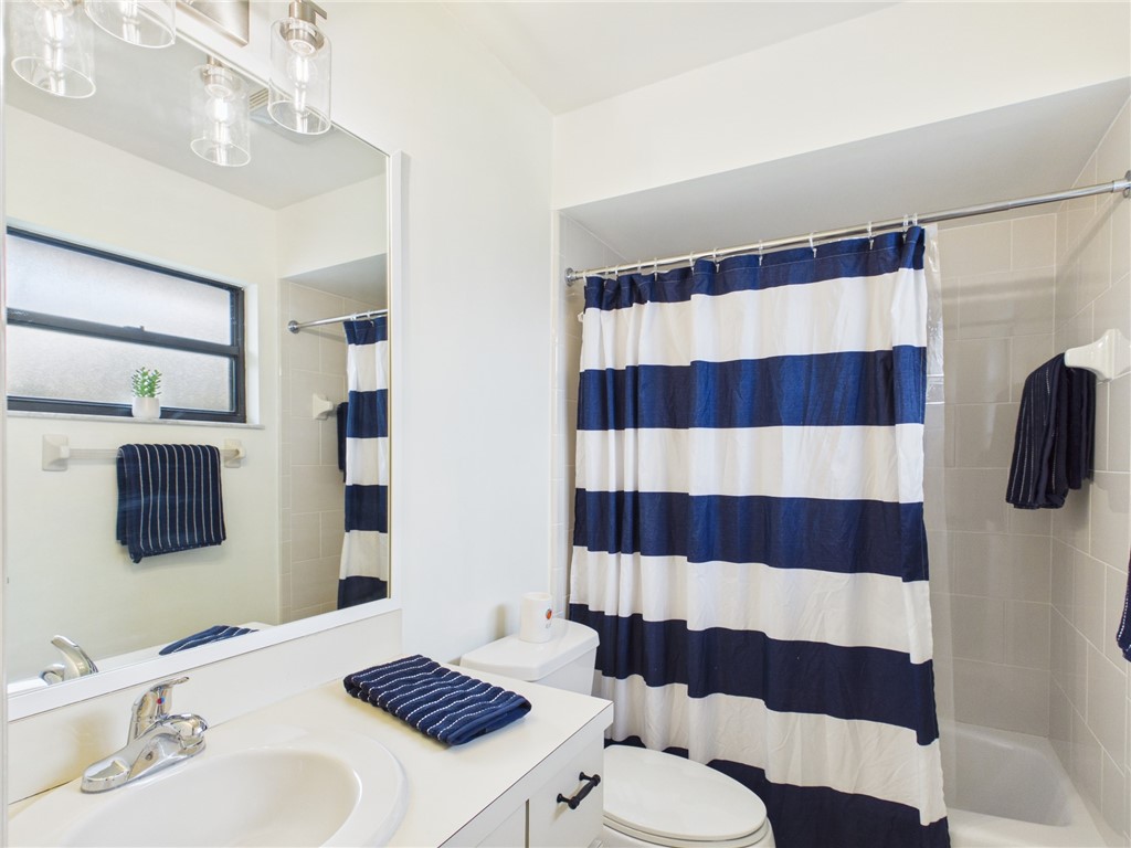225 Midvale Terrace Sebastian, FL 32958 - Photo 21 of 25 a bathroom with a sink a toilet a shower and mirror