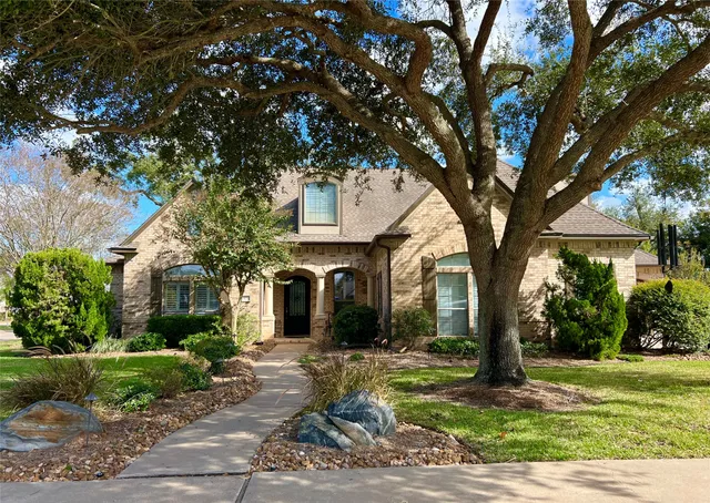 a tree in front of a white house