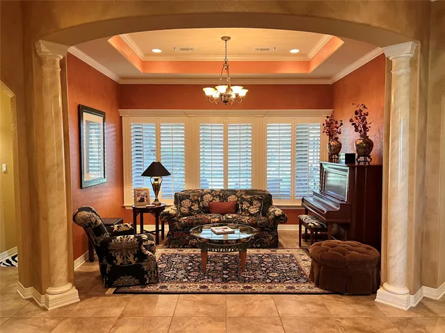 a living room with furniture and a chandelier