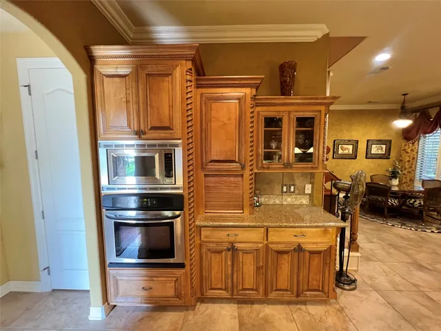 a kitchen with stainless steel appliances kitchen island granite countertop a refrigerator and a stove