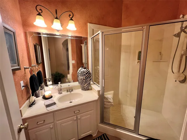 a bathroom with a mirror sink and a mirror