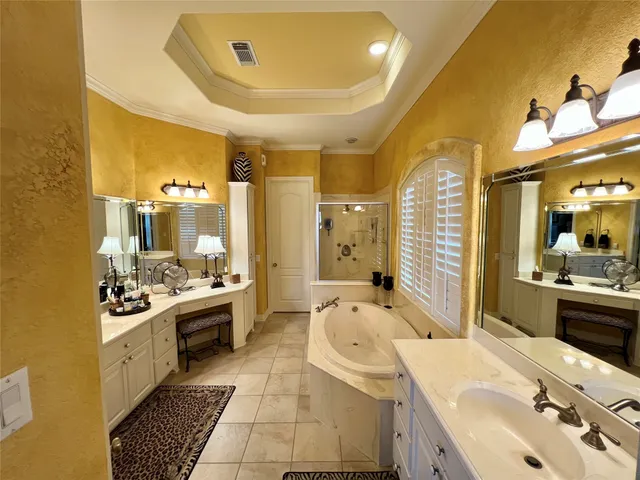a large bathroom with a sink mirror and a bathtub