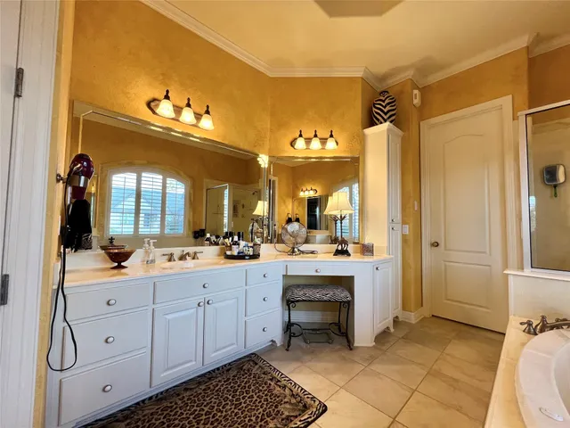a large bathroom with a double vanity sink toilet and shower
