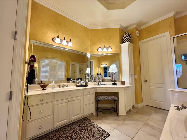 a large bathroom with a double vanity sink a mirror and a shower