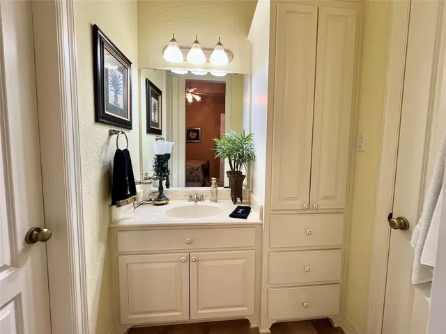a bathroom with a sink vanity and a mirror
