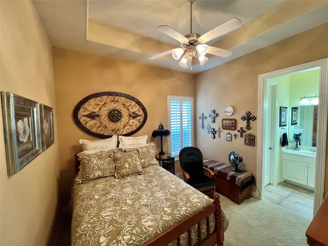 a bedroom with bed and a chandelier