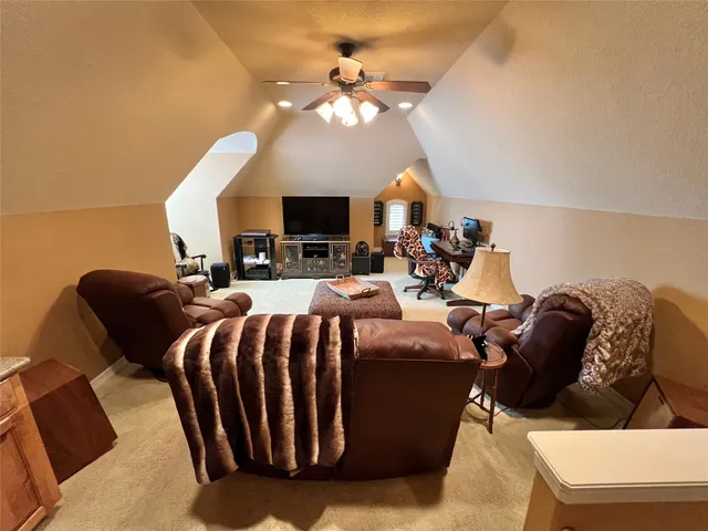 a living room with furniture a fireplace and a chandelier