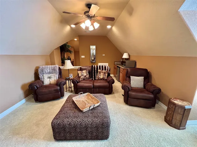 a living room with furniture and a ceiling fan