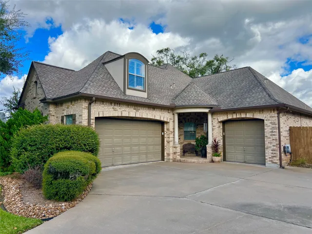 a front view of a house with a garage and outdoor seating