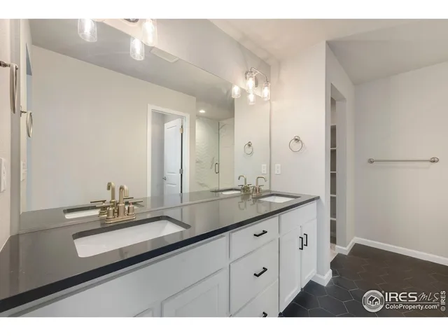 a bathroom with a sink double vanity and a mirror