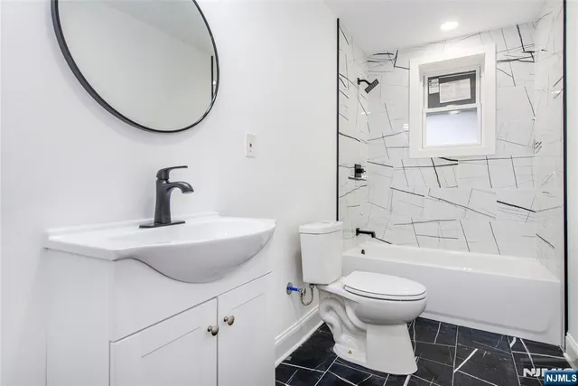 a bathroom with a toilet sink and shower