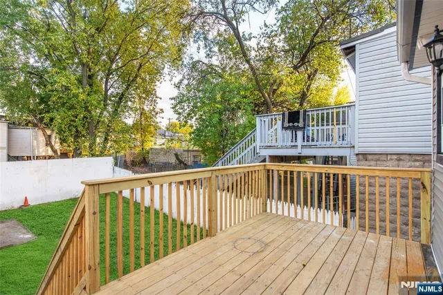 a view of balcony with wooden floor and fence