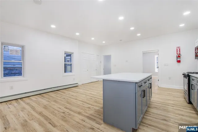 a kitchen with a sink and wooden floor