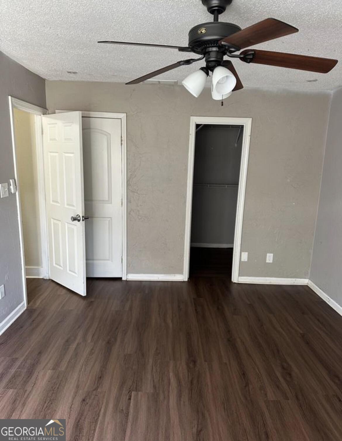 2725 Flintlock Place Austell, GA 30106 - Photo 12 of 28 a view of a livingroom with wooden floor and a ceiling fan