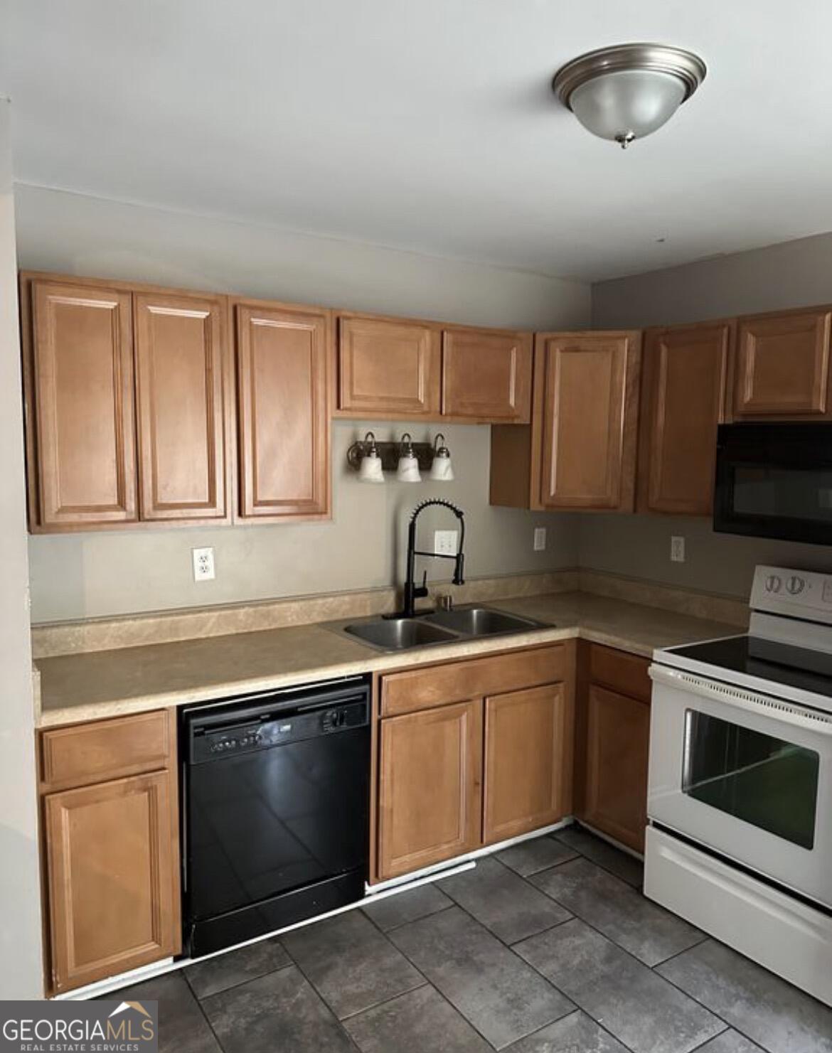 2725 Flintlock Place Austell, GA 30106 - Photo 7 of 28 a kitchen with a sink stove and microwave