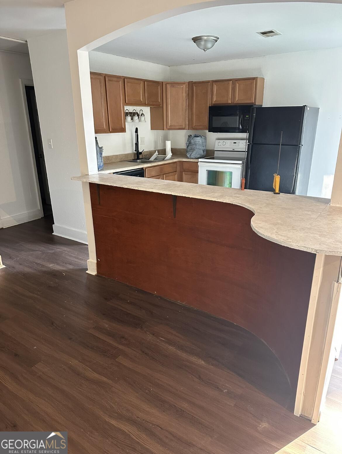 2725 Flintlock Place Austell, GA 30106 - Photo 8 of 28 a kitchen with stainless steel appliances granite countertop a sink a stove top oven a counter space and cabinets