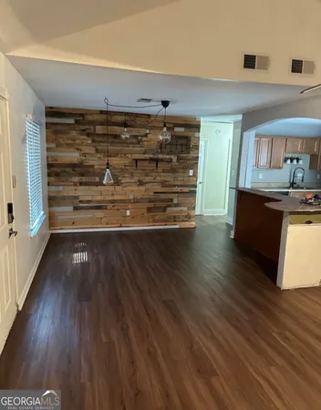 a view of wooden floor and windows in a room