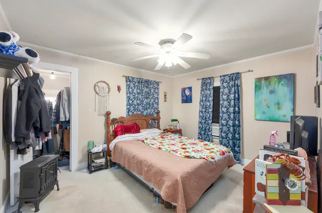 a bedroom with furniture and wooden floor