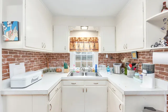 a kitchen with a sink cabinets and window