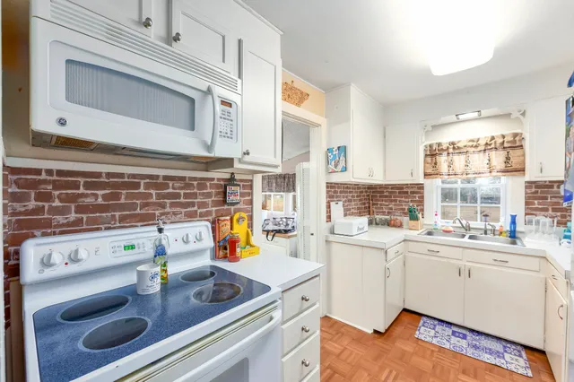 a kitchen with a sink stove and cabinets