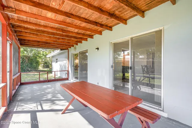 a room with pool table and windows