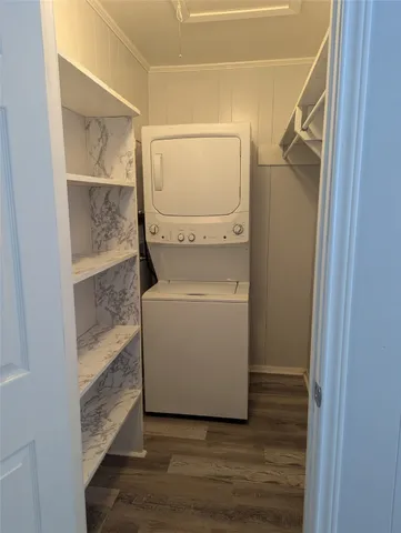 a utility room with wooden floor washer and dryer