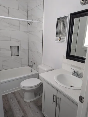 a bathroom with a sink toilet a mirror and shower