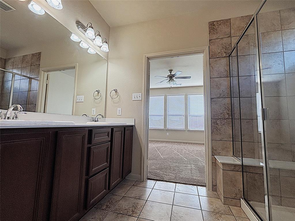 9435 Smoke Tree Drive Forney, TX 75126 - Photo 18 of 36 a bathroom with a double vanity sink and a mirror
