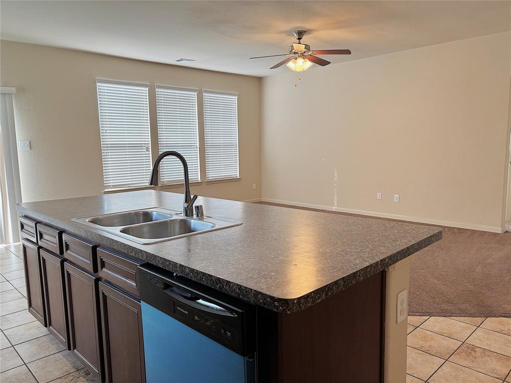 9435 Smoke Tree Drive Forney, TX 75126 - Photo 7 of 36 a kitchen with a sink a counter and appliances