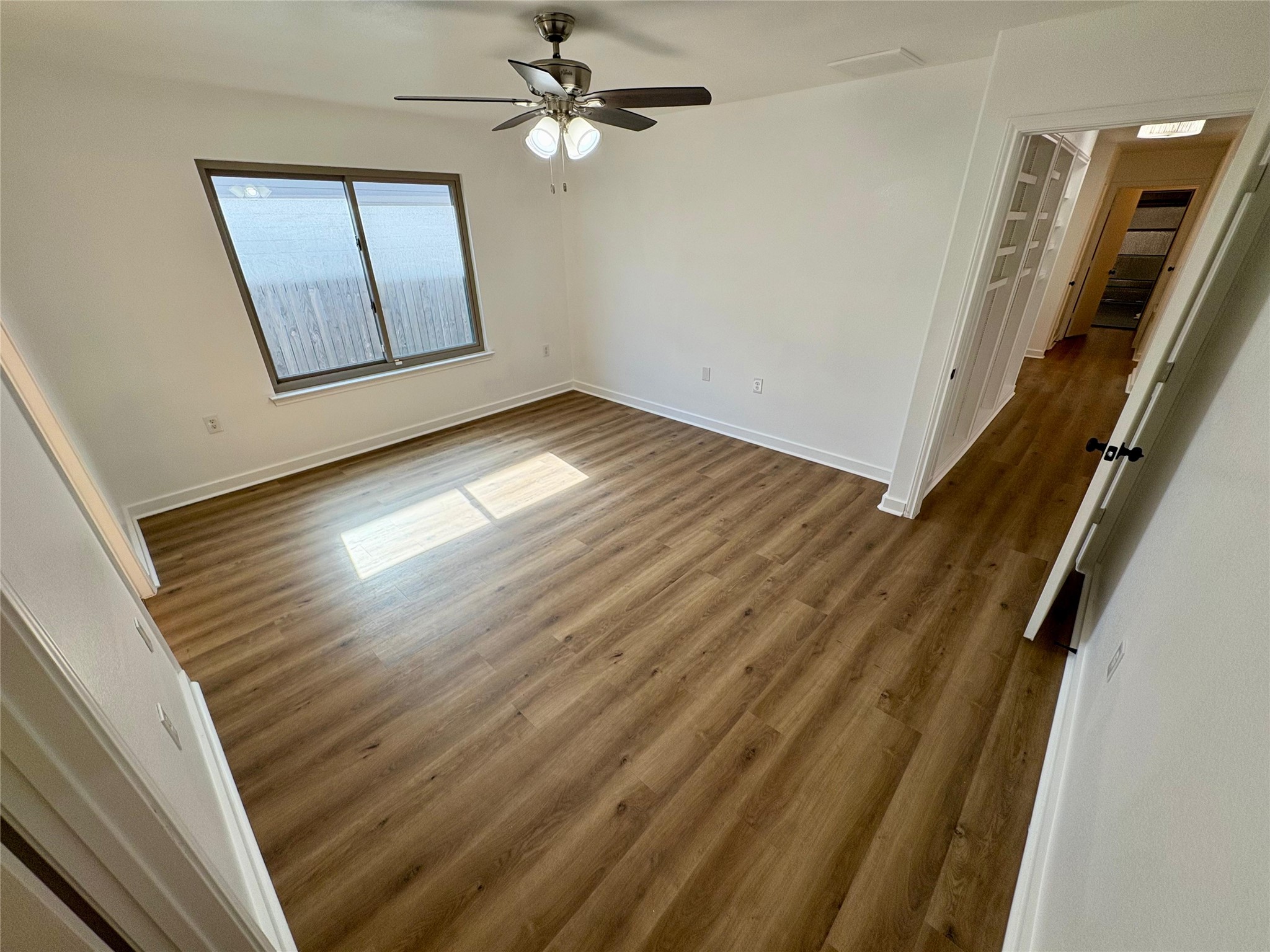 8003 Bannock Lane Austin, TX 78747 - Photo 17 of 40 Master bedroom with dark wood finished floors and ceiling fan