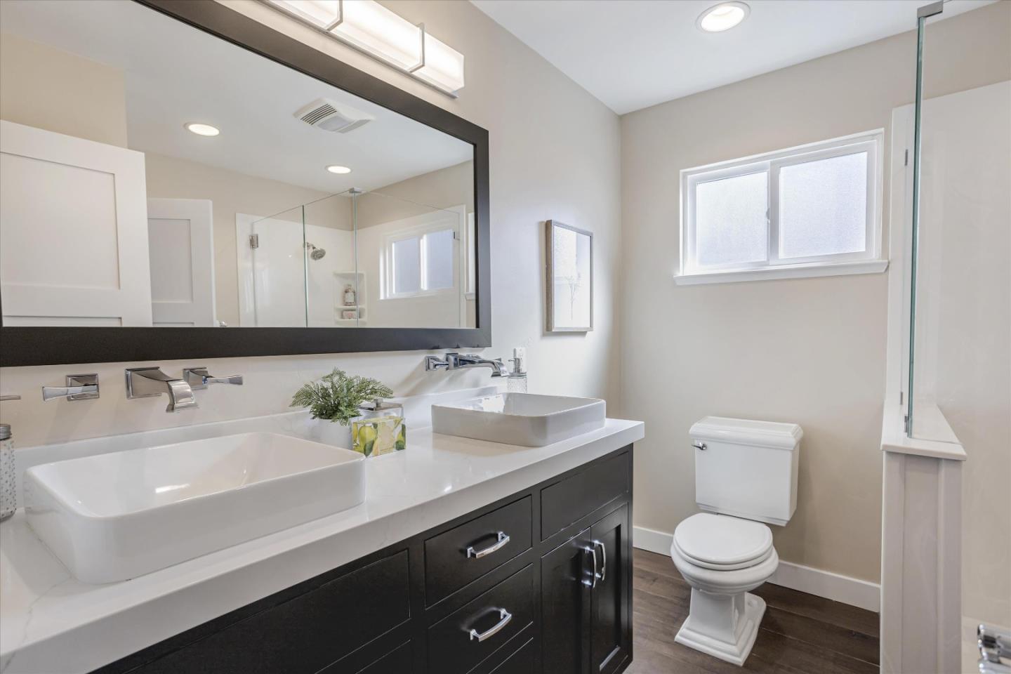 1716 Grizilo Drive San Jose, CA 95124 - Photo 29 of 49 a bathroom with a sink a toilet and a mirror