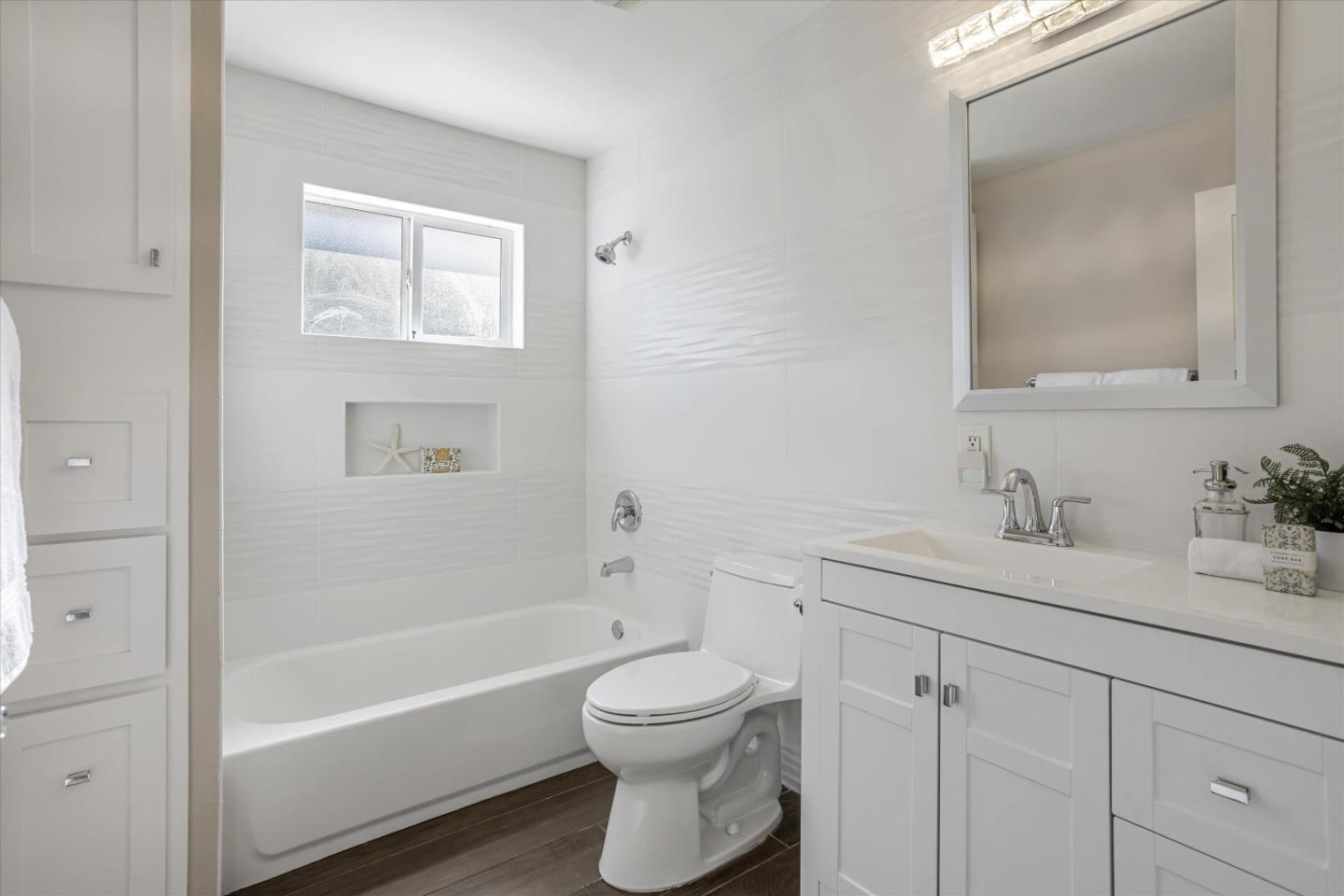 1716 Grizilo Drive San Jose, CA 95124 - Photo 32 of 49 a bathroom with a granite countertop toilet a sink and a bathtub
