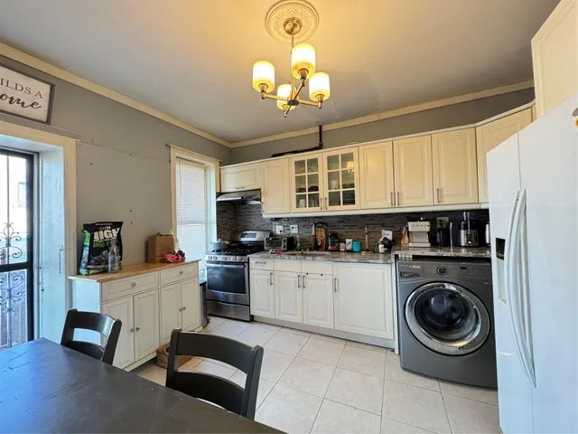 a kitchen with a stove a sink and cabinets