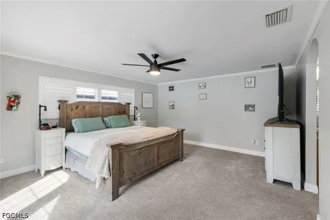 a bedroom with a bed and a ceiling fan