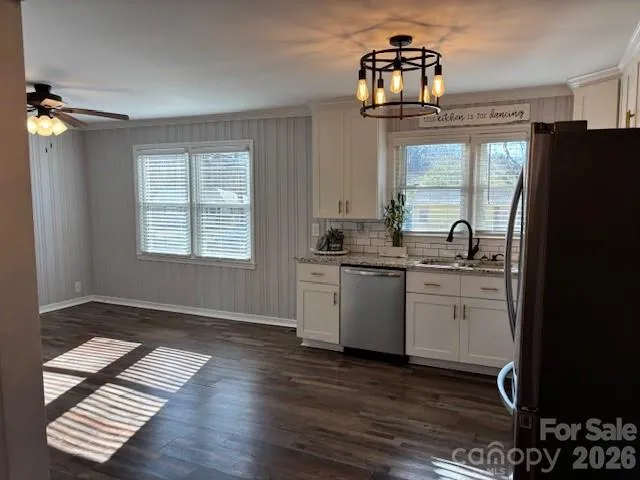a kitchen with a refrigerator and a stove